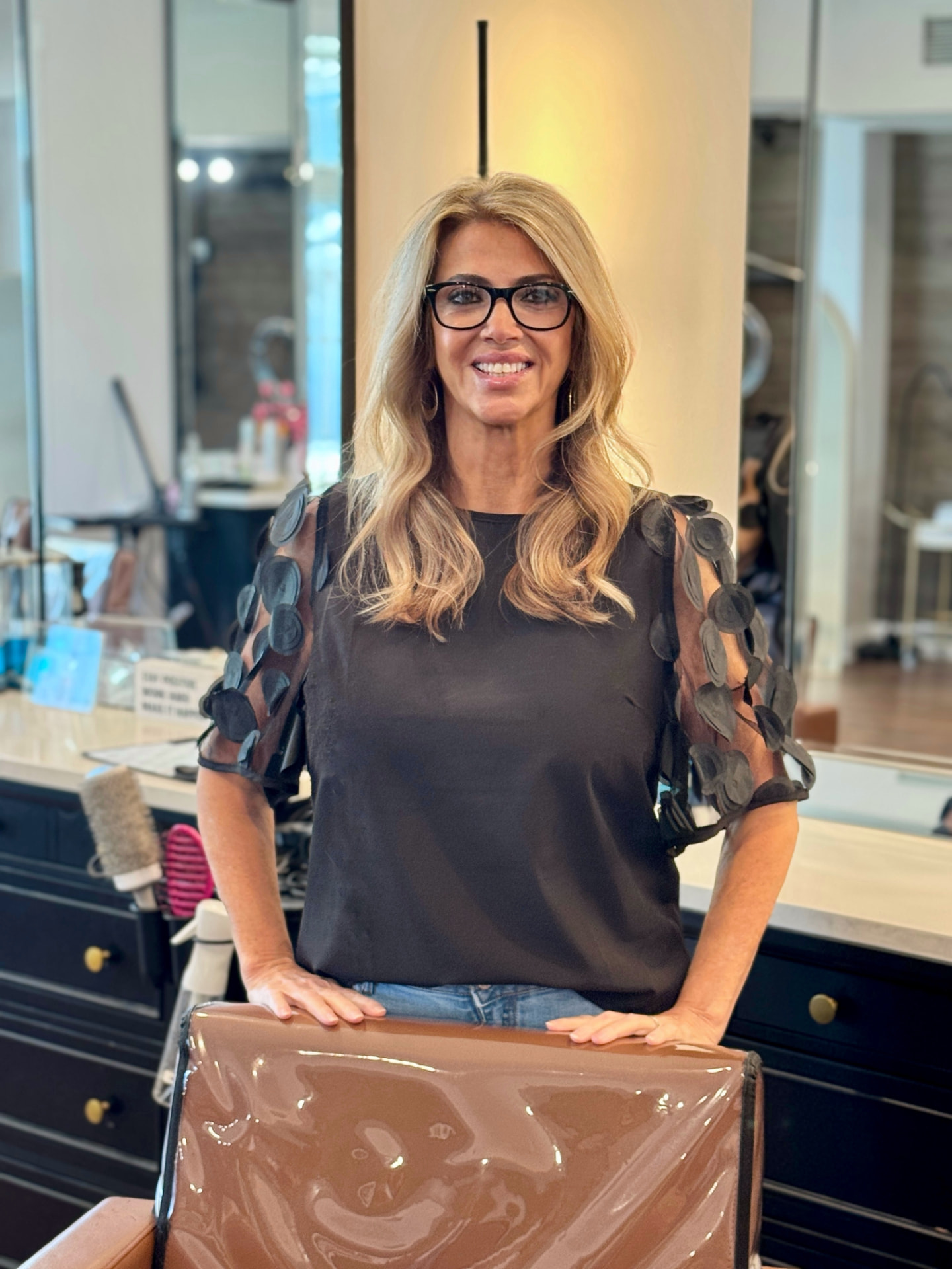 Blonde Studio 4 Salon stylist smiling inside the Pass Christian salon