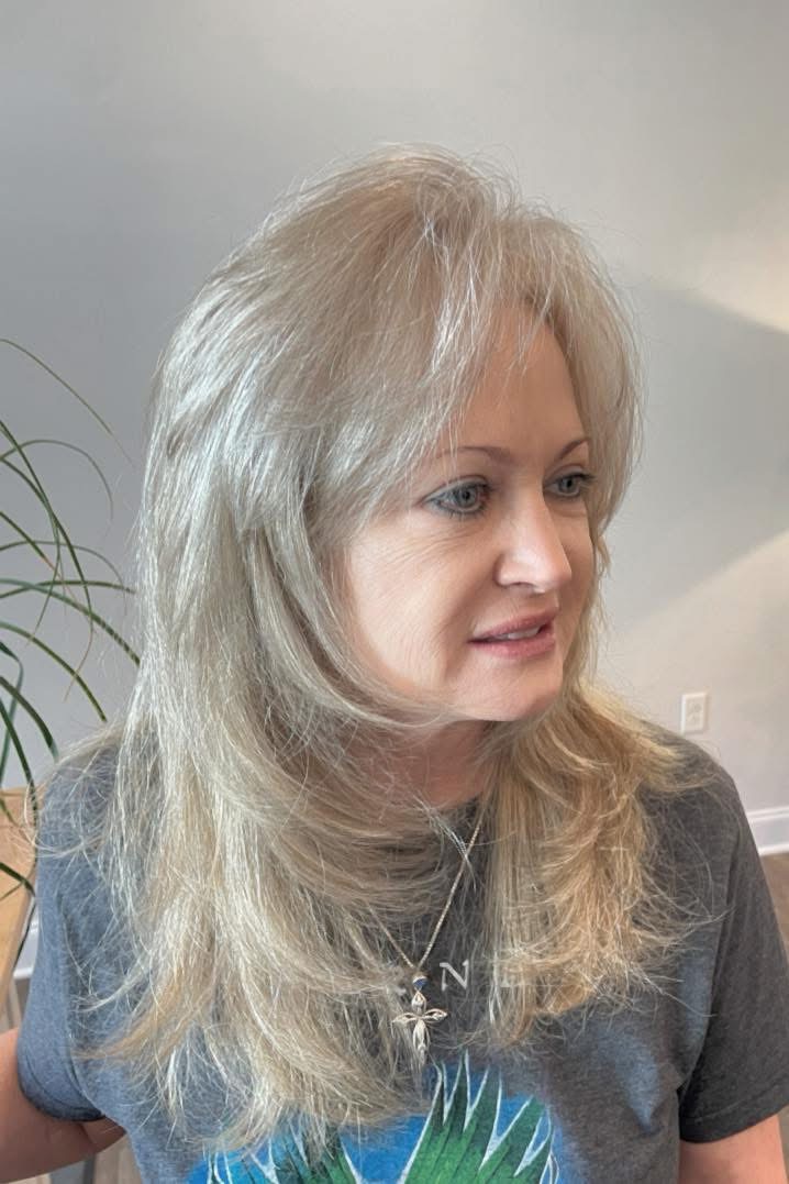Layered voluminous blonde hair by Studio 4 Salon on the Gulf Coast