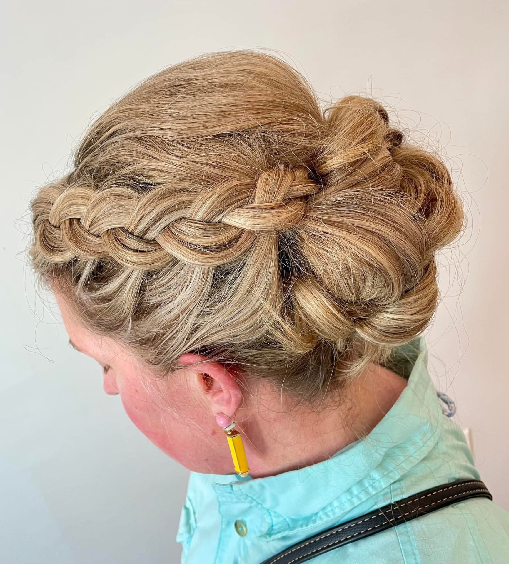 Intricate blonde braided updo for a special occasion by Studio 4 Salon