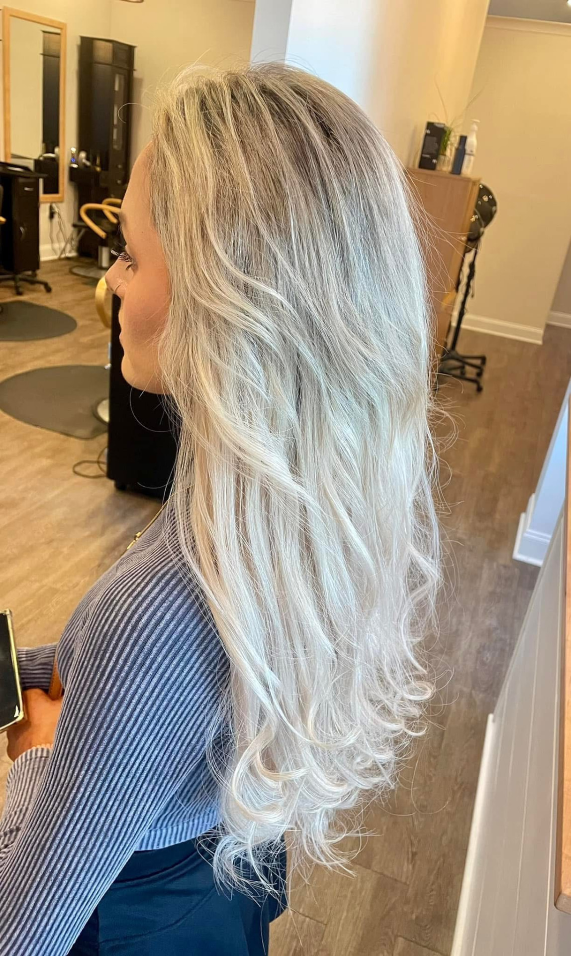 Long icy blonde wavy hair by Studio 4 Salon in Pass Christian, MS