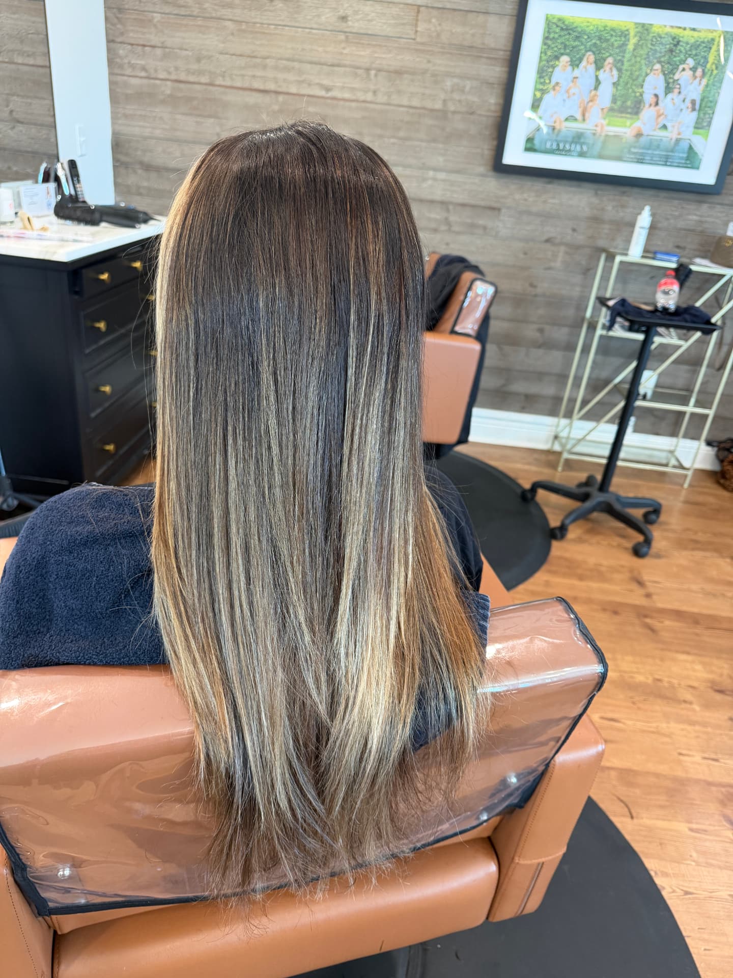 Long dimensional brunette balayage with blonde highlights by Studio 4 Salon