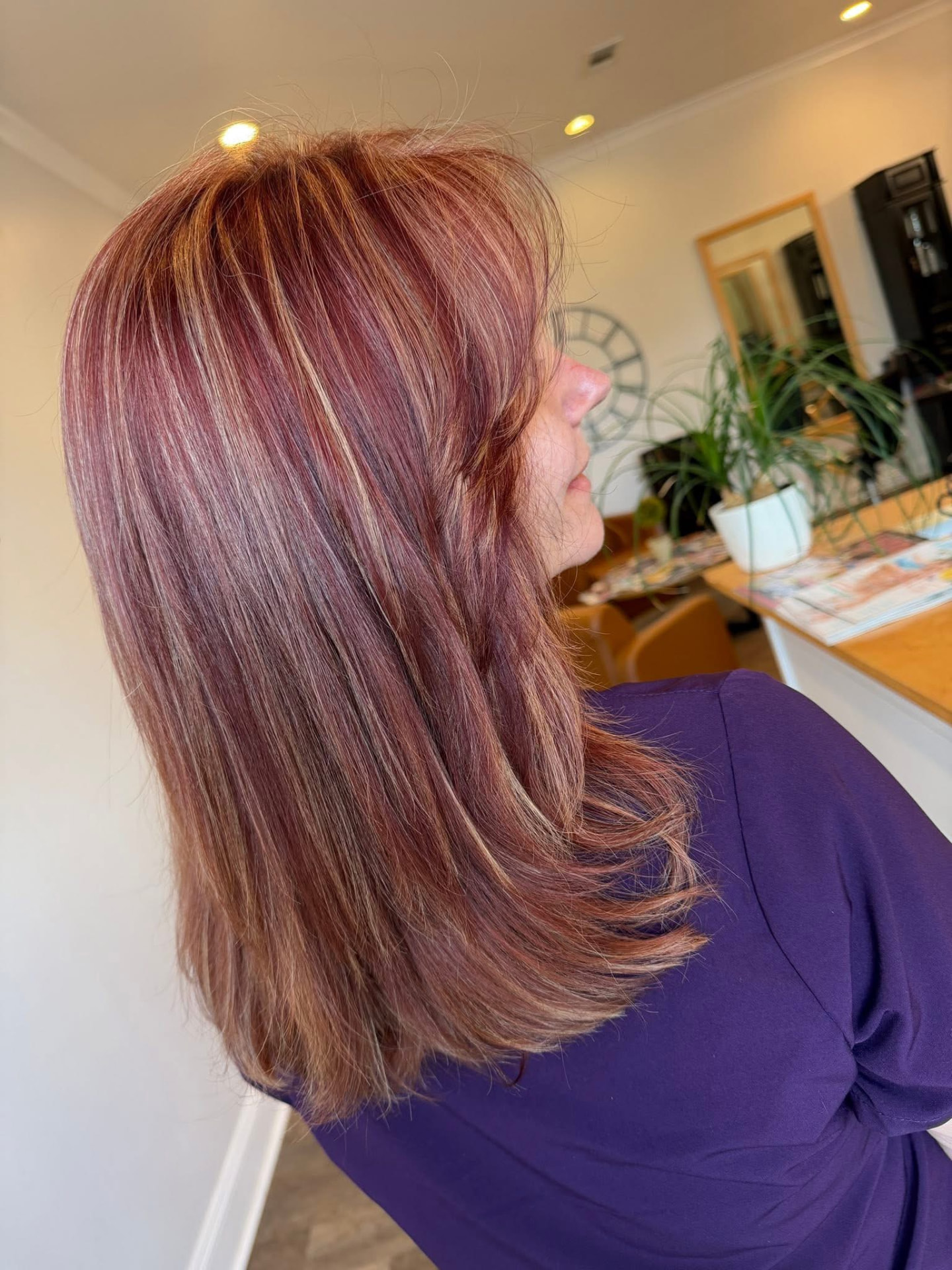 Long reddish-brown hair with blonde highlights by Studio 4 Salon in Pass Christian