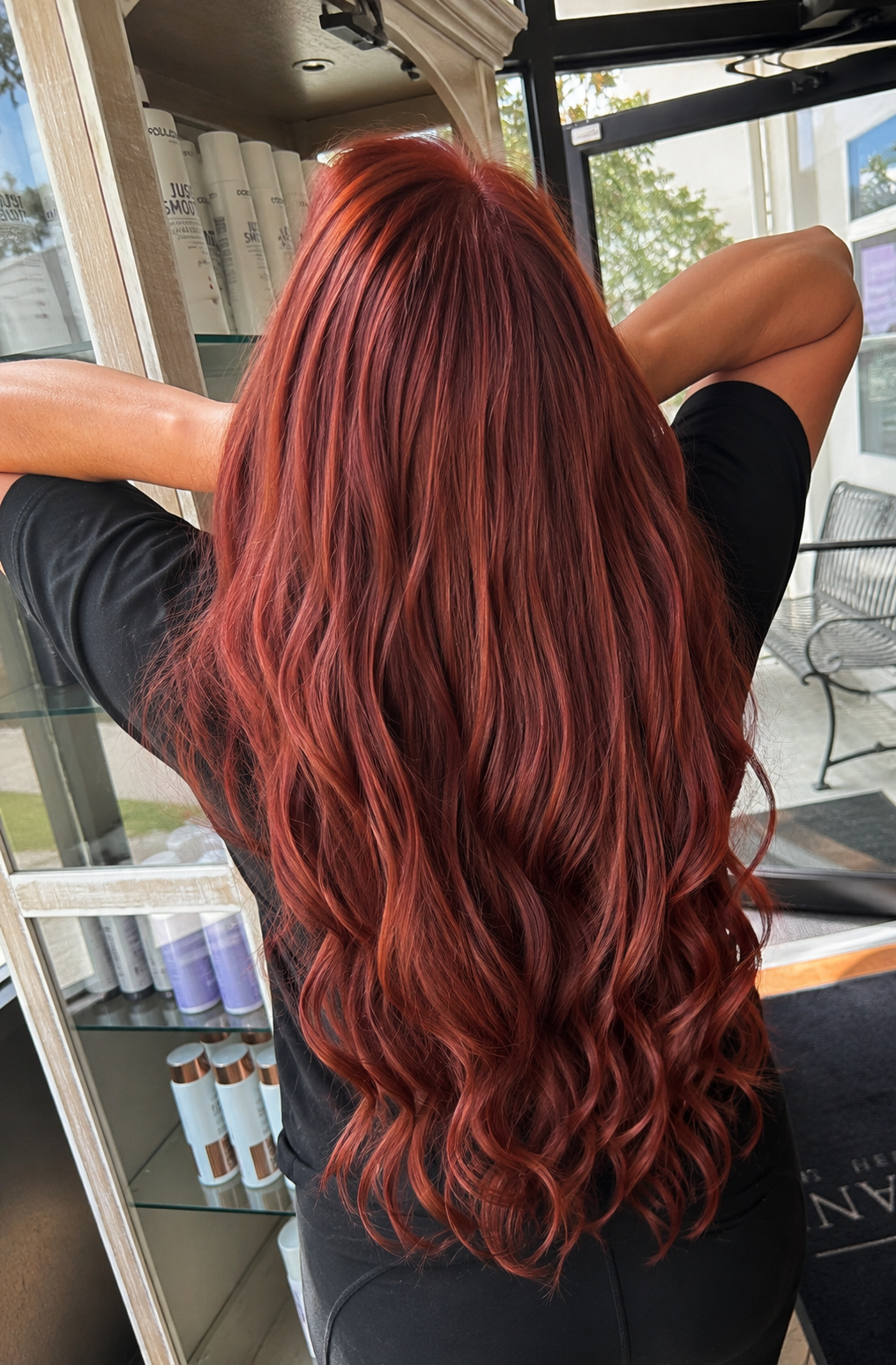 Long vibrant red wavy hair by Studio 4 Salon on the Mississippi Gulf Coast
